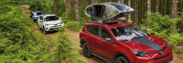 The 2018 RAV4 hauling kayaks in the woods in a blog post about Toyota cars in Raleigh, NC.